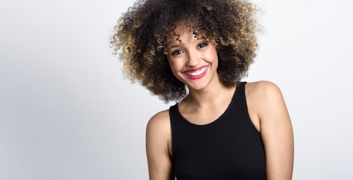 Young black woman with afro hairstyle smiling